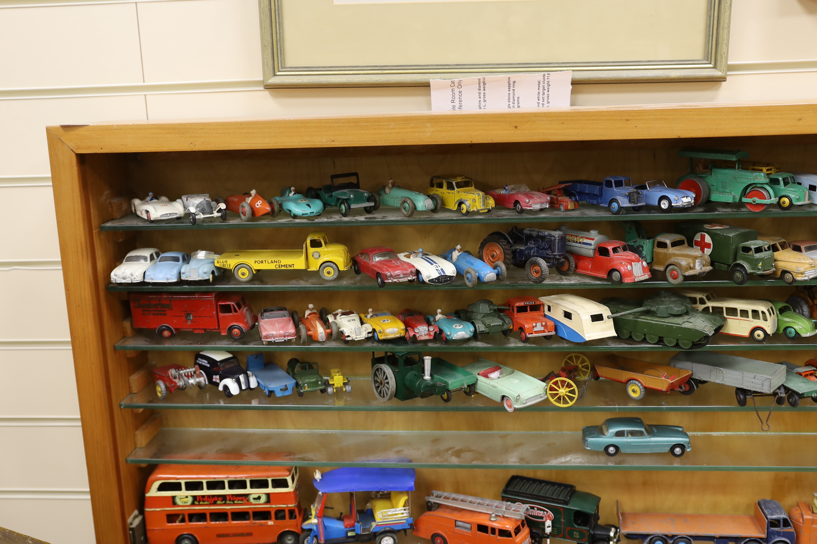 A collection of diecast vehicles in display case